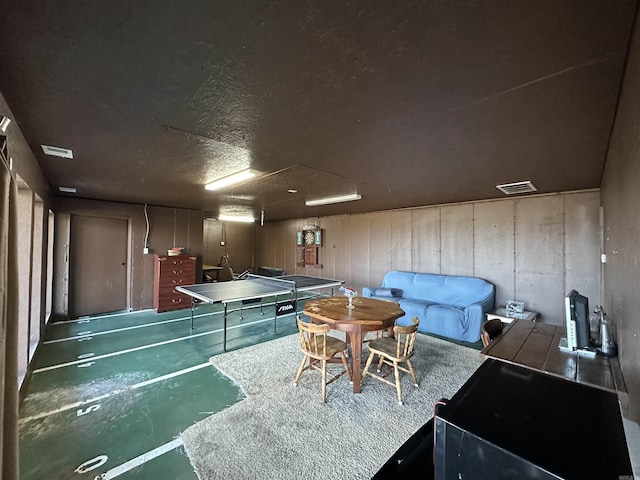 recreation room featuring a textured ceiling