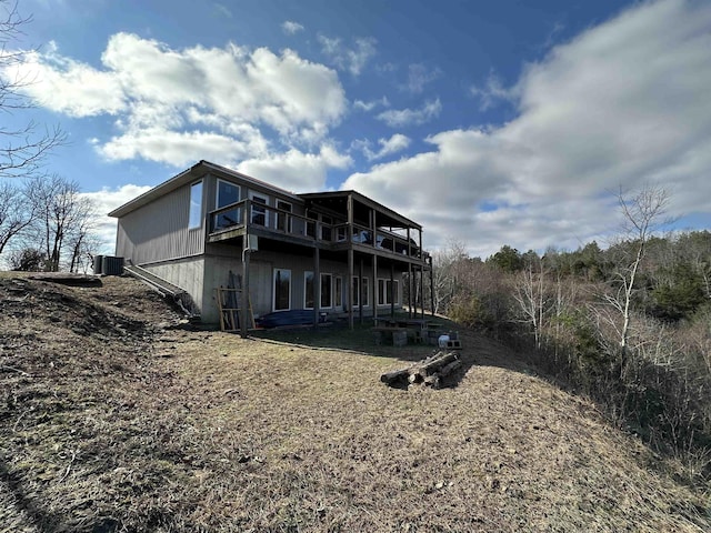 back of house featuring a deck and central AC