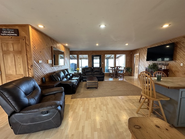 living room featuring wood walls and light wood-type flooring