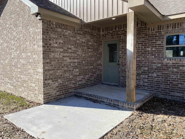 view of exterior entry featuring a patio