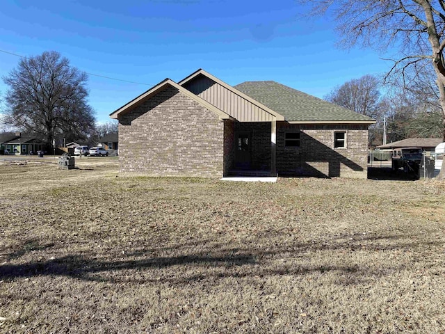 view of side of property with a lawn