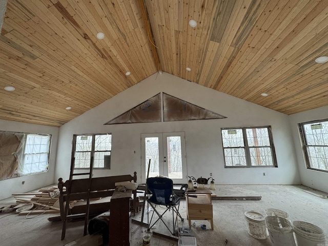 interior space featuring beam ceiling, french doors, and high vaulted ceiling