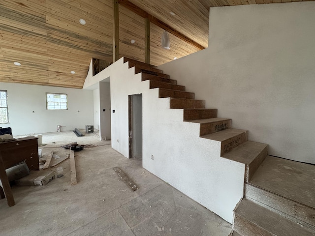 stairs with wood ceiling and high vaulted ceiling