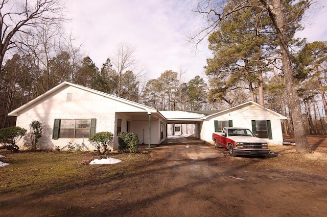 single story home featuring a carport