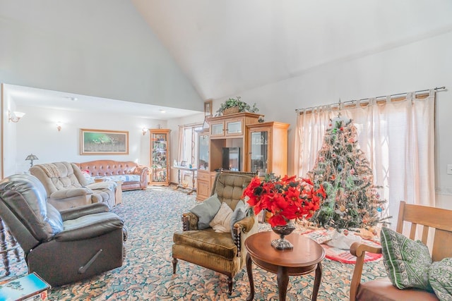 living room featuring high vaulted ceiling and carpet floors