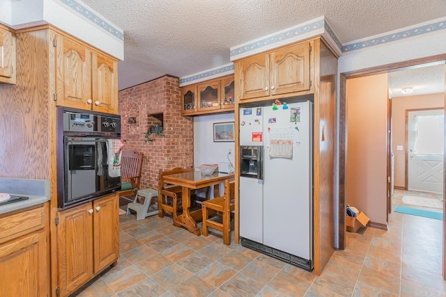 kitchen featuring white refrigerator with ice dispenser, black oven, and a textured ceiling