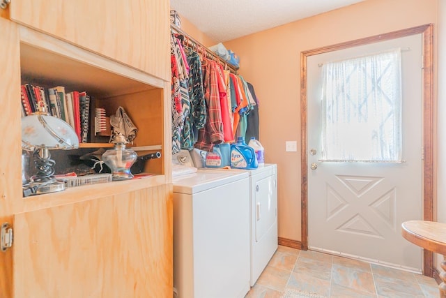 laundry area with washer and dryer and cabinets