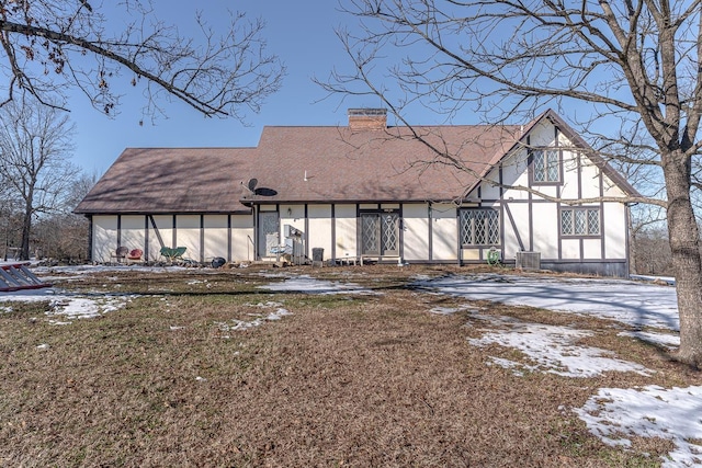 view of snow covered rear of property