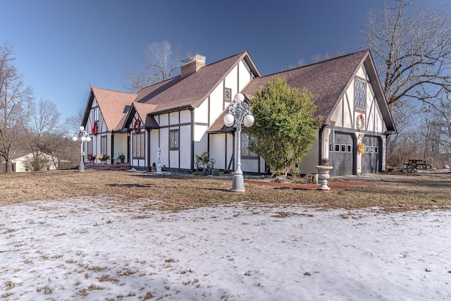 view of snow covered exterior with a garage