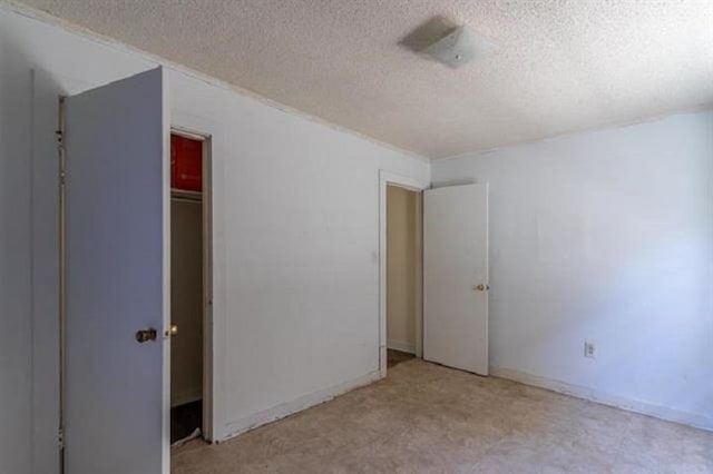 unfurnished bedroom with a closet and a textured ceiling