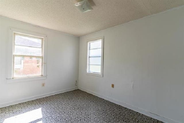 empty room featuring a textured ceiling