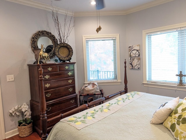 bedroom featuring crown molding and multiple windows