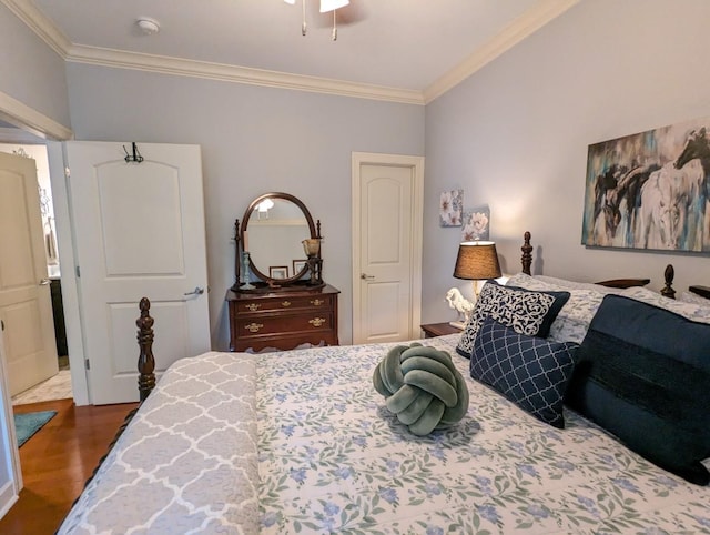 bedroom featuring ornamental molding and dark hardwood / wood-style flooring