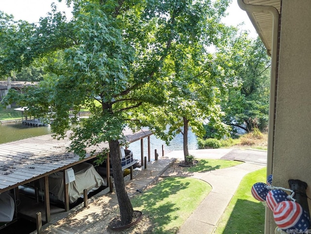 view of yard featuring a boat dock and a water view