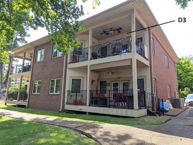 back of property with ceiling fan, cooling unit, and a balcony