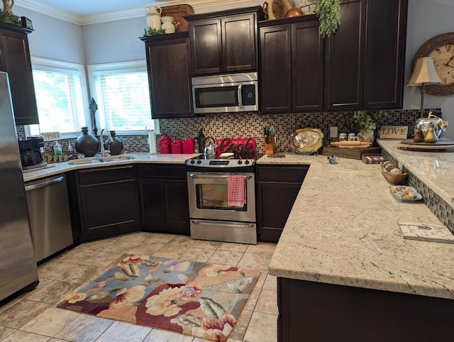 kitchen with sink, appliances with stainless steel finishes, ornamental molding, and tasteful backsplash