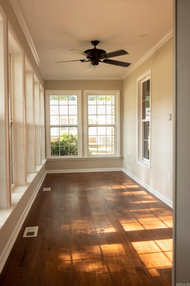 unfurnished sunroom with ceiling fan and plenty of natural light