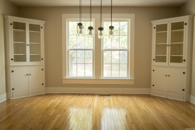 unfurnished dining area with light hardwood / wood-style flooring