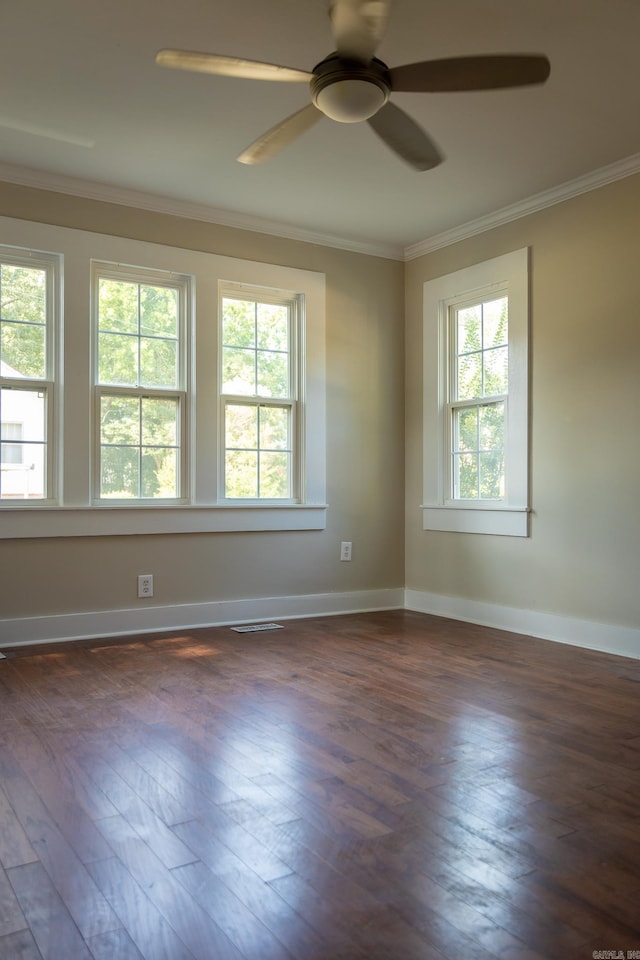 unfurnished room featuring ceiling fan, dark hardwood / wood-style floors, and crown molding