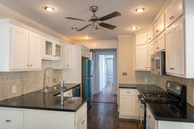 kitchen featuring stainless steel appliances, ornamental molding, white cabinets, and tasteful backsplash