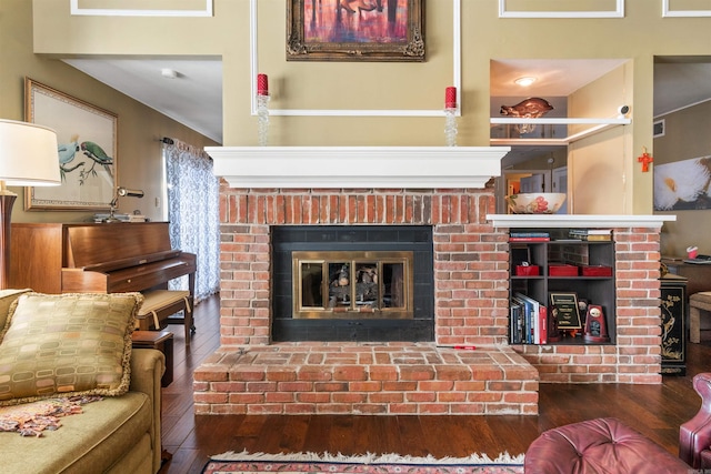 living room with a fireplace and dark hardwood / wood-style flooring