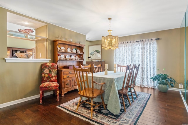 dining space with an inviting chandelier and dark hardwood / wood-style floors