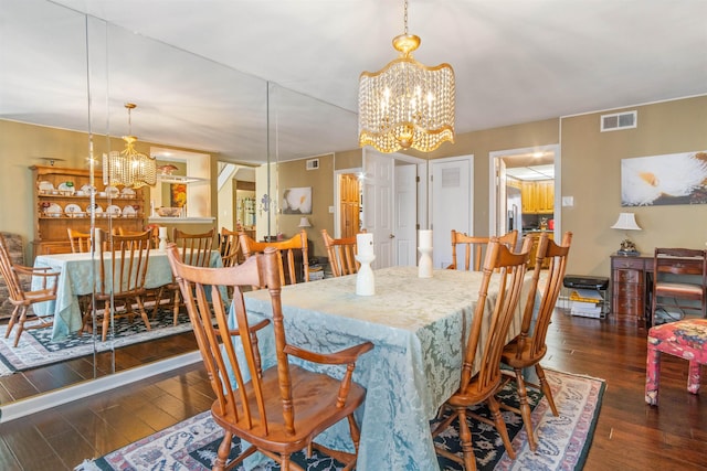 dining room with an inviting chandelier and dark hardwood / wood-style floors