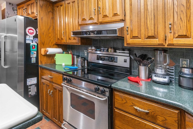 kitchen featuring backsplash, appliances with stainless steel finishes, and light tile patterned flooring