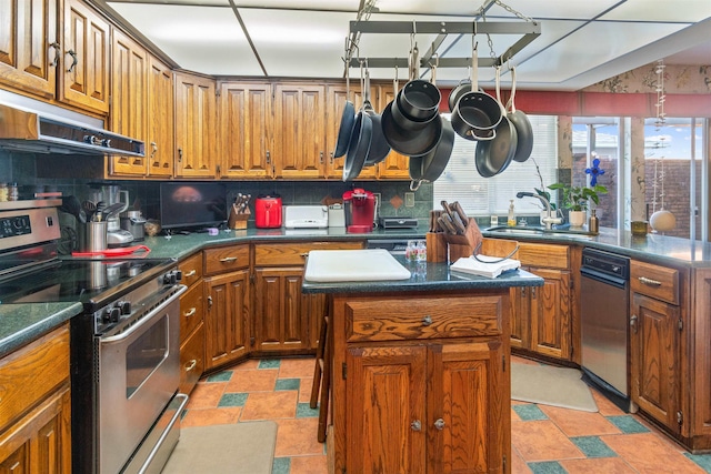 kitchen featuring a kitchen island, decorative backsplash, stainless steel electric range oven, and sink