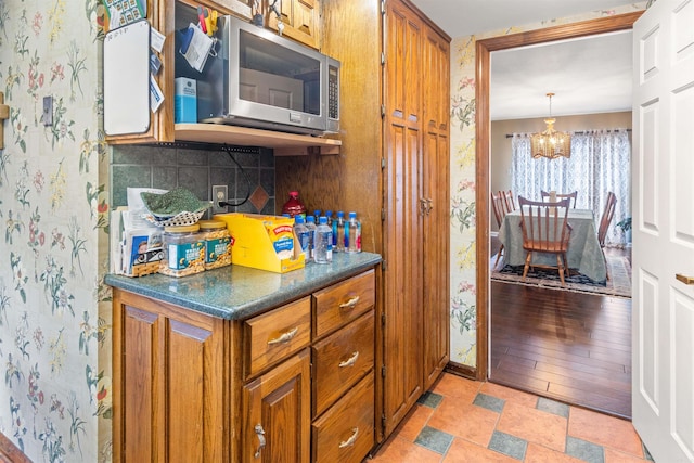 kitchen with hanging light fixtures, a notable chandelier, and tasteful backsplash