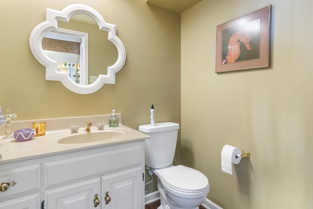 bathroom featuring toilet and vanity