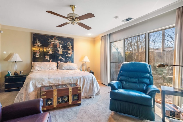 carpeted bedroom featuring ceiling fan and ornamental molding