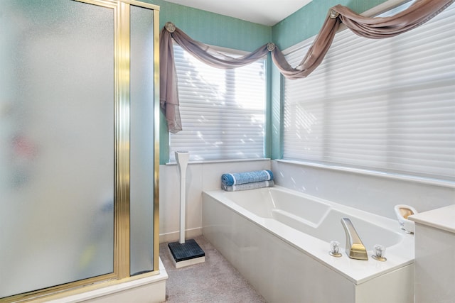 bathroom featuring shower with separate bathtub