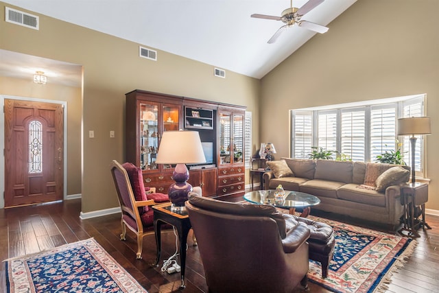 living room with ceiling fan, dark wood-type flooring, and high vaulted ceiling