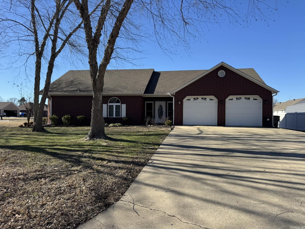 ranch-style home featuring a front yard and a garage