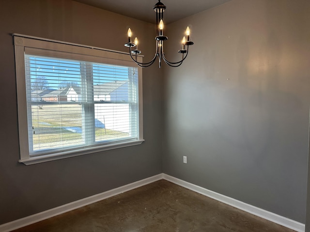 spare room featuring a notable chandelier