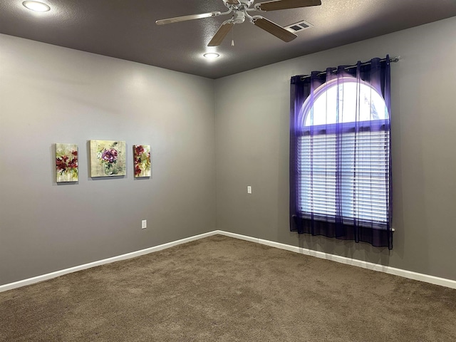 unfurnished room featuring ceiling fan and carpet flooring