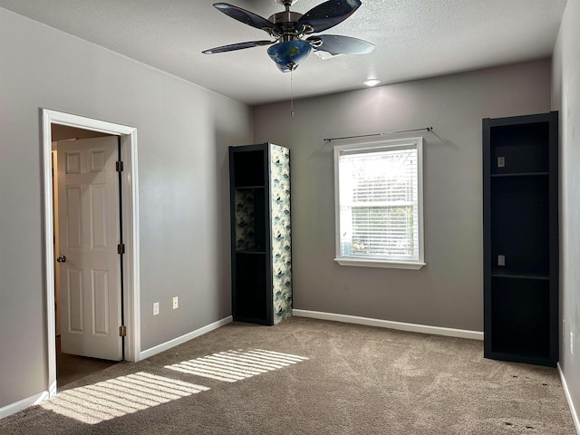 unfurnished bedroom with ceiling fan and light colored carpet