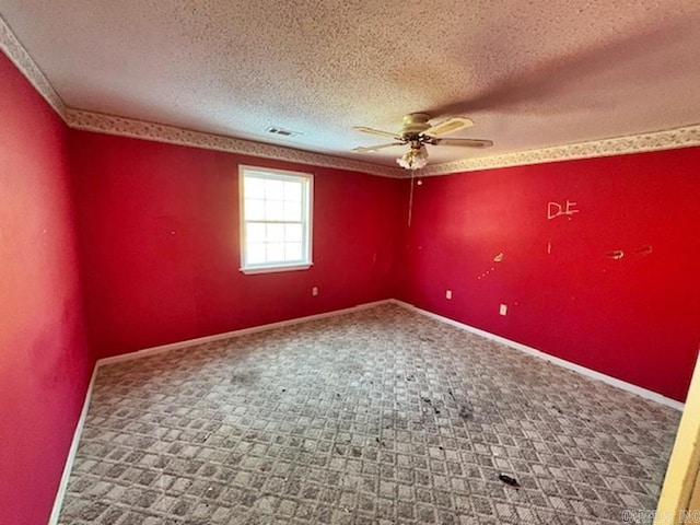 spare room featuring a textured ceiling, ceiling fan, and carpet floors