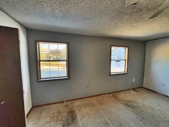 unfurnished room featuring a textured ceiling