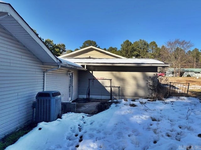 view of snow covered exterior with cooling unit