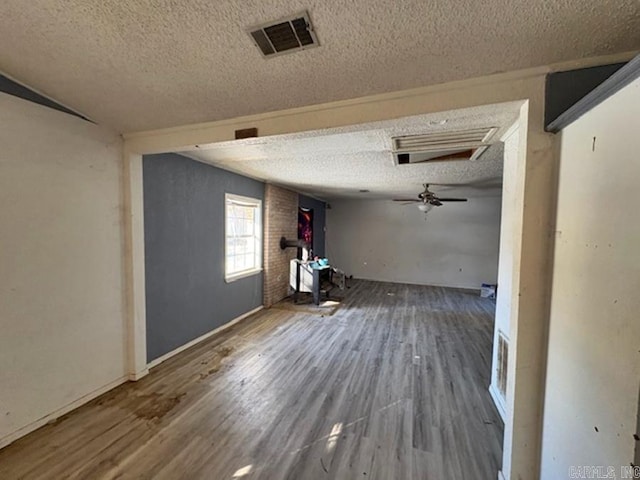 hall with a textured ceiling and hardwood / wood-style floors