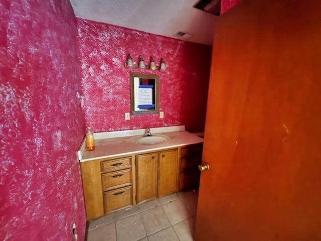 bathroom featuring tile patterned flooring and vanity