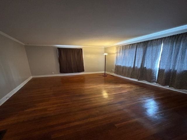 unfurnished room featuring dark hardwood / wood-style flooring and crown molding