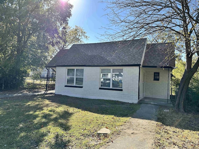 view of side of property with a lawn