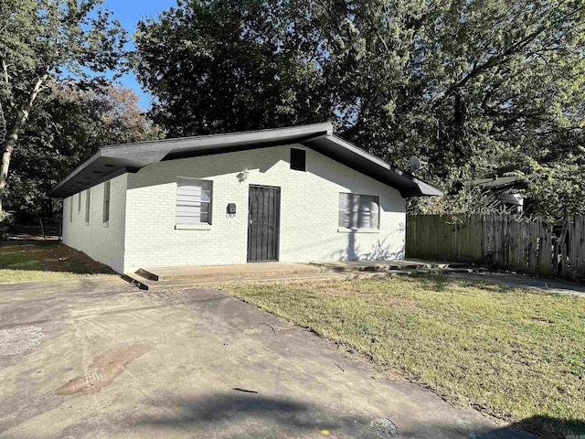 view of front facade with a front lawn and a patio