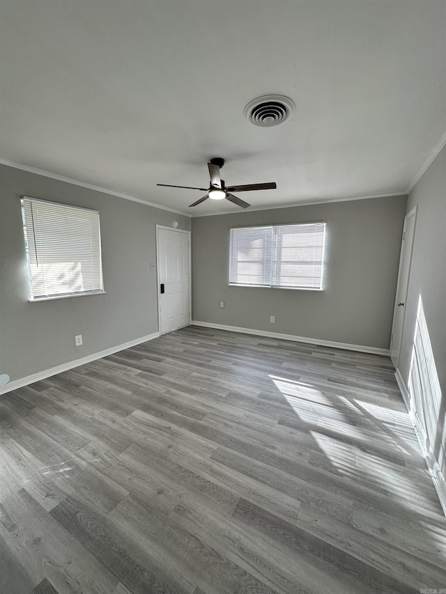 spare room with ceiling fan, crown molding, and light hardwood / wood-style floors