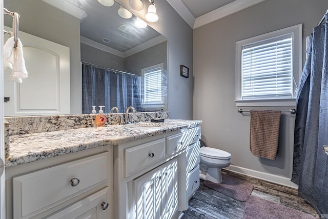 bathroom featuring toilet, vanity, ornamental molding, and hardwood / wood-style flooring