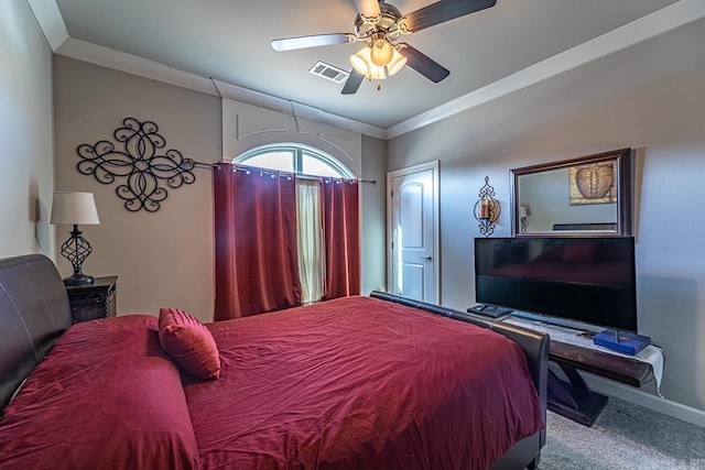 carpeted bedroom featuring ceiling fan and ornamental molding