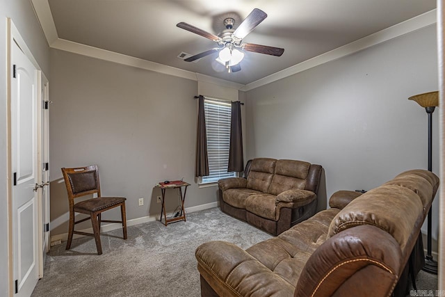 carpeted living room with ceiling fan and ornamental molding